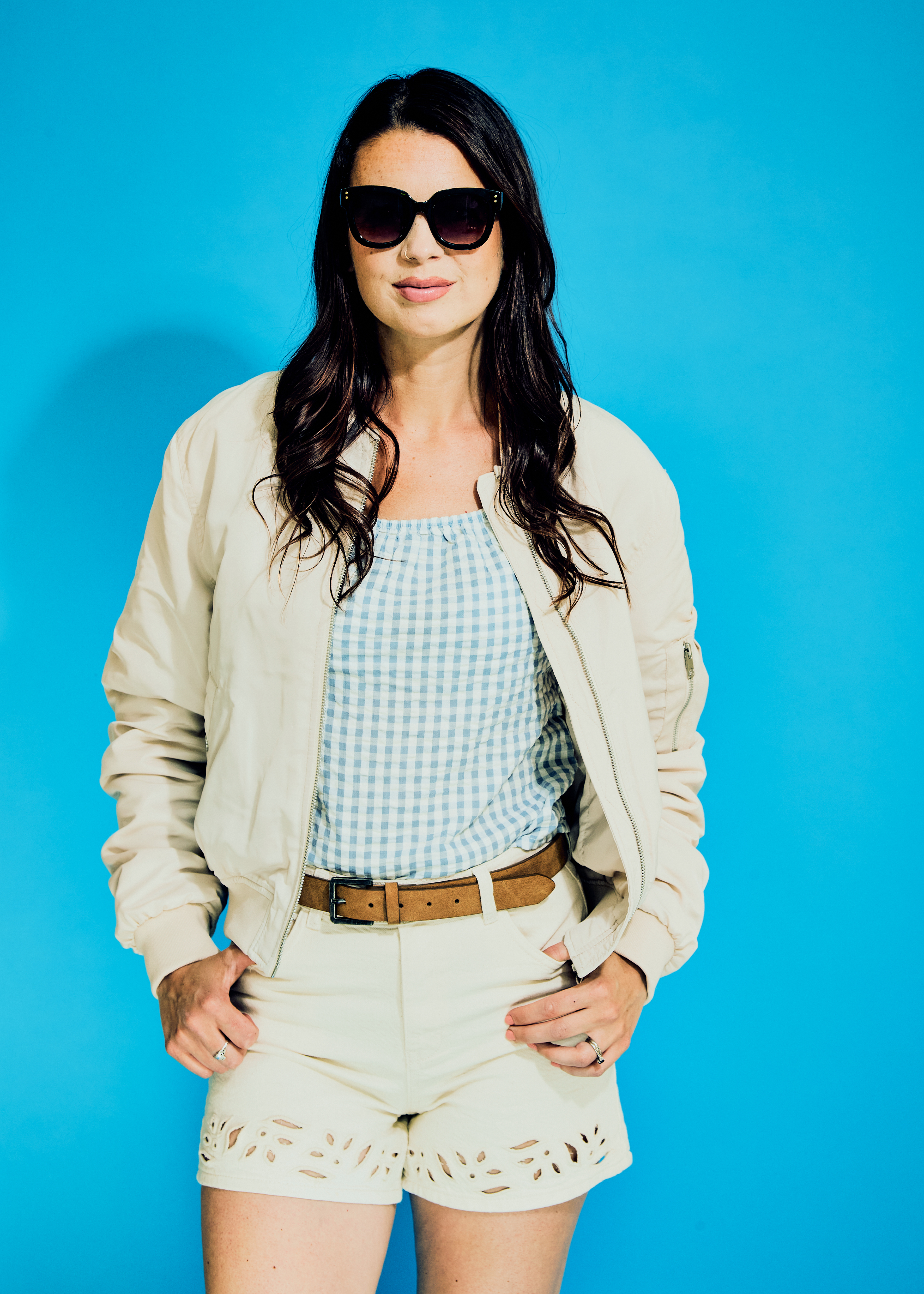Individual sporting sunglasses and children's clothing.